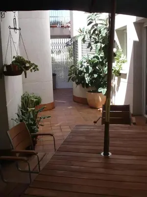 a room with potted plants and an umbrella at Comfortable House in Sitges with Shared Pool in Sitges