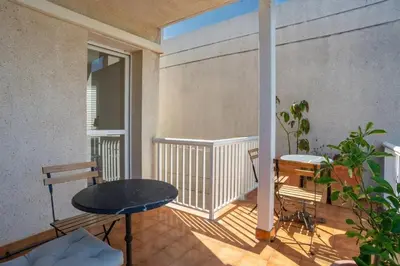 a balcony with a table and chairs on it at Comfortable House in Sitges with Shared Pool in Sitges