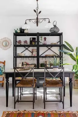 a dining room table with two chairs and a shelf at Con patio y a 5 minutos de la playa in Sitges