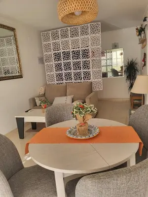 a living room with a table and chairs at ESPIGALL in Vilanova i la Geltrú