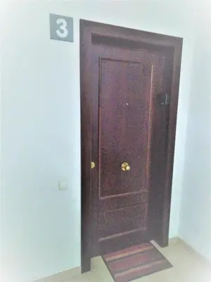 a brown door in a room with a sign on it at ESPIGALL in Vilanova i la Geltrú