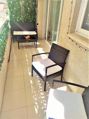 a balcony with two chairs and a bench on it at ESPIGALL in Vilanova i la Geltrú