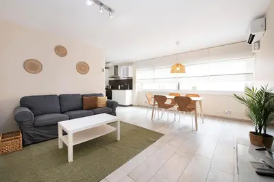 a living room with a couch and a table at White Sea by Seasidehomes in Castelldefels