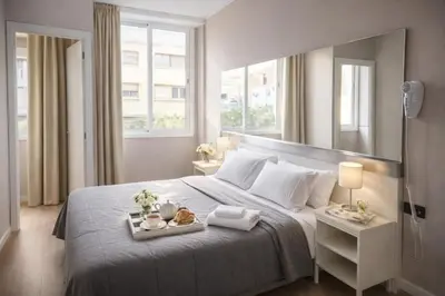 a bedroom with a bed with two towels on it at Aparthotel Montcada in Montcada i Reixac
