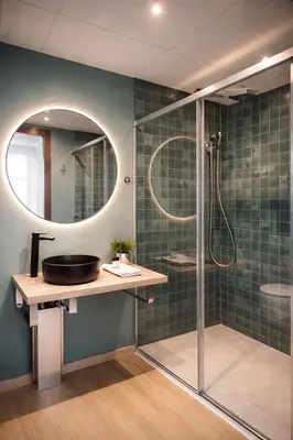 a bathroom with a shower and a white sink at Aparthotel Montcada in Montcada i Reixac