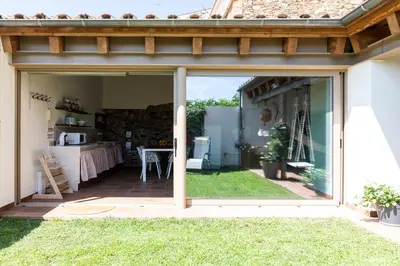 a sliding glass door leading into a kitchen with a patio at RUSTIC & CHIC b&b in Granollers