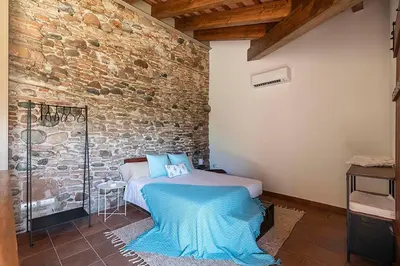 a bedroom with a bed and a brick wall at RUSTIC & CHIC b&b in Granollers