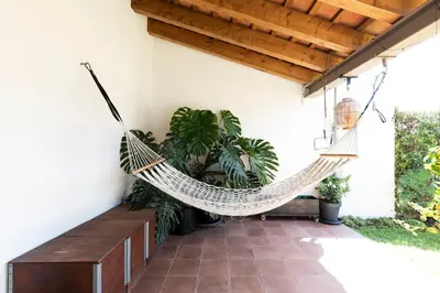 a hammock hanging from a porch with plants at RUSTIC & CHIC b&b in Granollers