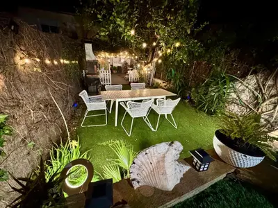 a living room with a couch and a tree with lights at casa en Masnou junto a playa y tren in Masnou