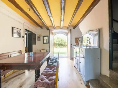 a dining room with a wooden table and yellow ceilings at Mansion in St Martí with Vineyards & Garden in San Martín Sarroca