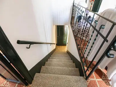 a staircase leading up to a green door at Mansion in St Martí with Vineyards & Garden in San Martín Sarroca