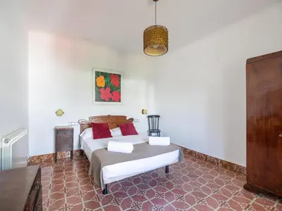 a bedroom with a bed with red pillows at Mansion in St Martí with Vineyards & Garden in San Martín Sarroca