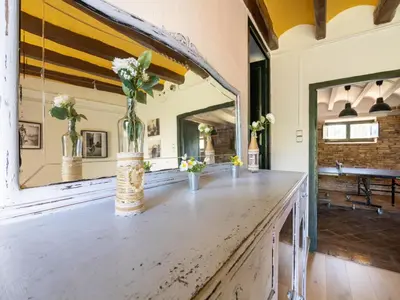 a large mirror in a room with a wooden table at Mansion in St Martí with Vineyards & Garden in San Martín Sarroca