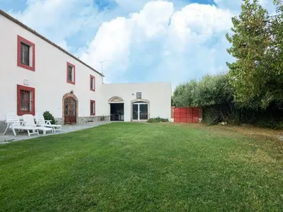 a white house with a lawn in front of it at Mansion in St Martí with Vineyards & Garden in San Martín Sarroca