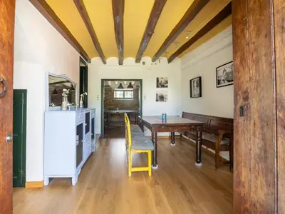 a dining room with a table and a yellow chair at Mansion in St Martí with Vineyards & Garden in San Martín Sarroca