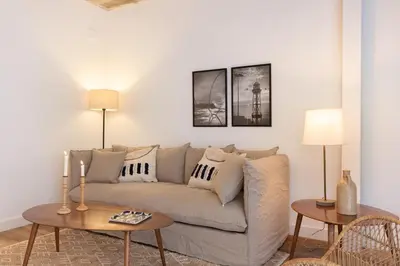 a living room with a couch and two tables at En Casa de Calders 5 in Barcelona