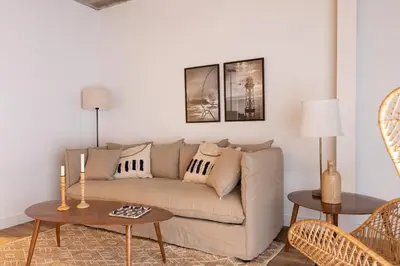 a living room with a couch and two tables at En Casa de Calders 5 in Barcelona