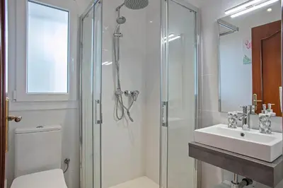 a bathroom with a shower and a toilet and a sink at HOUSE WITH AMAZING VIEWS , OVERLOOKING THE FESTIVAL TOWN OF SITGES in Sitges