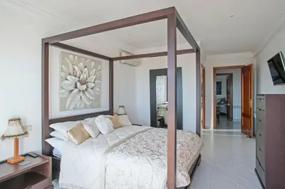 a bedroom with a large bed with a canopy at HOUSE WITH AMAZING VIEWS , OVERLOOKING THE FESTIVAL TOWN OF SITGES in Sitges