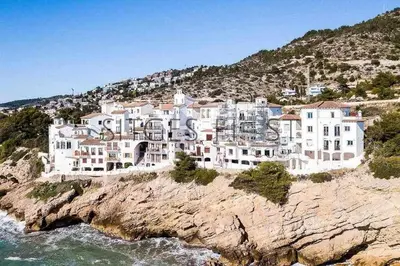 a large building on a cliff next to the ocean at Sitges Blue - completamente reformado en 2025 in Sitges