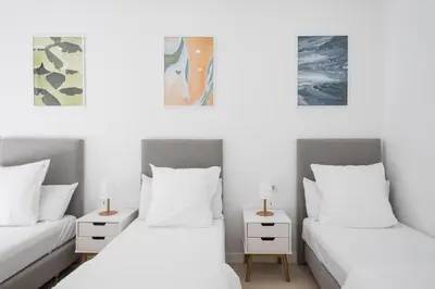 two beds in a room with white walls at No Limit Barcelona Central in Barcelona