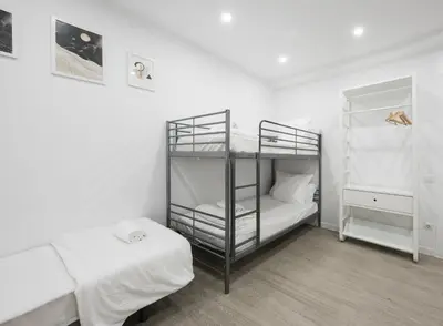 a room with two bunk beds and a table at No Limit Barcelona Central in Barcelona