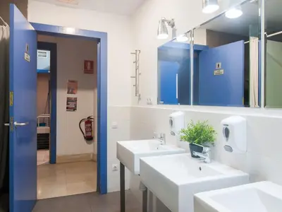 a bathroom with two sinks and a mirror at No Limit Barcelona Central in Barcelona
