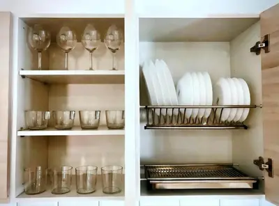 a cupboard filled with plates and wine glasses at Mon Residence Sant Jeroni in Manresa