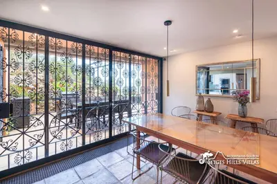 a room with a wooden dresser with a mirror on it at VILLA DUMAS with amazing sea views, AC and private pool in Sitges