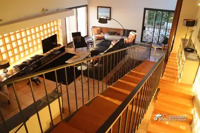 a bedroom with a large bed and a couch at VILLA DUMAS with amazing sea views, AC and private pool in Sitges