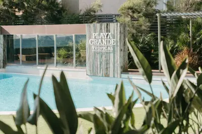 a sign that reads playa grande turkey next to a swimming pool at Playa Grande by Tropical in Gavà
