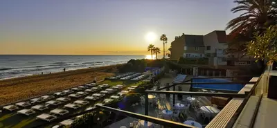a view of a beach with tables and chairs at Playa Grande by Tropical in Gavà
