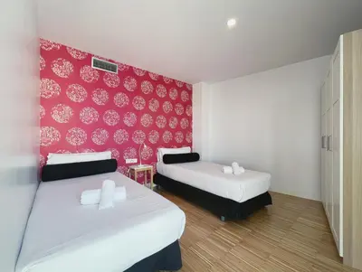 a bedroom with two beds and a red wall at Stay U-nique Apartments Pellaires in Barcelona