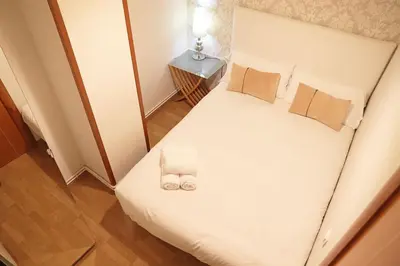 a bedroom with a bed with two wedding shoes on it at Bcn-rentals apartments in the Old town in Barcelona