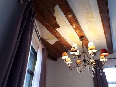 a chandelier hanging from a ceiling at Beautiful Apartment on Las Ramblas with Port views in Barcelona