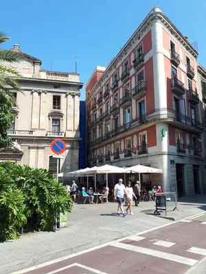 a group of people walking on a street with buildings at Beautiful Apartment on Las Ramblas with Port views in Barcelona