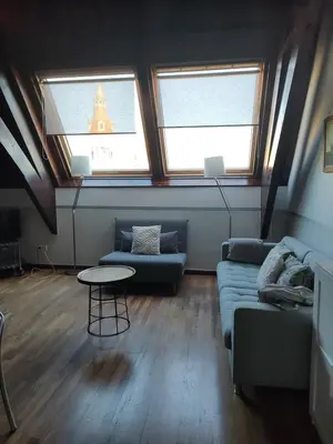 a living room with a couch and two windows at Passeig De Gràcia Luxury in Barcelona