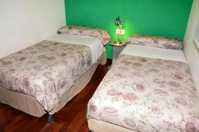 two beds in a room with green walls at Passeig De Gràcia Luxury in Barcelona