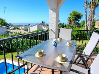 a table and chairs on the balcony of a house at Holiday Home Envalira by Interhome in Cunit