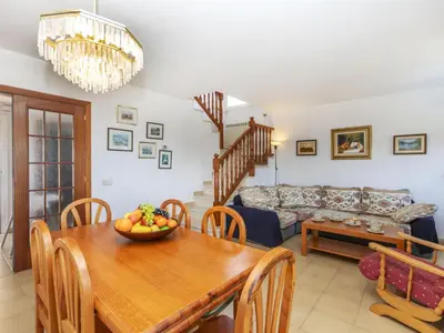 a living room with a table and a couch at Holiday Home Envalira by Interhome in Cunit