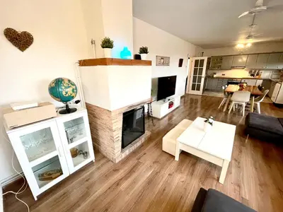 a living room with a fireplace and a couch at CASA PARAÍSO PISCINA TRANQUILIDAD in Sant Cebrià de Vallalta