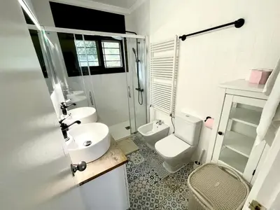 a bathroom with a sink and a toilet and a shower at CASA PARAÍSO PISCINA TRANQUILIDAD in Sant Cebrià de Vallalta