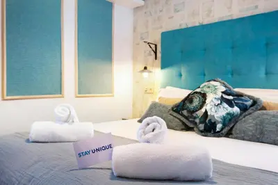 a hotel room with two towels on a bed at Stay U-nique Apartments Ramón y Cajal in Barcelona