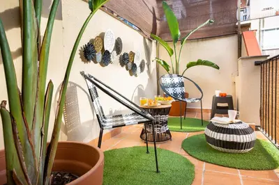 a balcony with a table and chairs and plants at Stay U-nique Apartments Ramón y Cajal in Barcelona