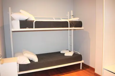 a room with two bunk beds in a room at Alguera Hola Apartments in Barcelona