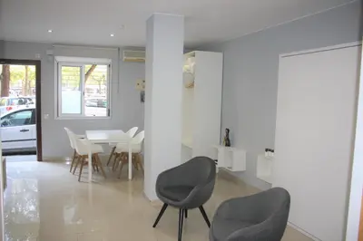 a dining room with chairs and a table in a house at Alguera Hola Apartments in Barcelona