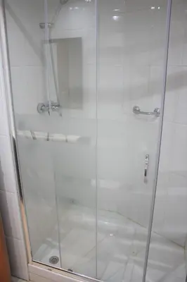 a shower with a glass door in a bathroom at Alguera Hola Apartments in Barcelona