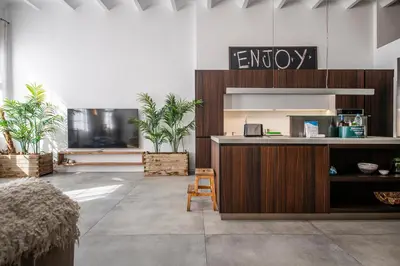 an empty lobby with a desk and potted plants at Poble Nou I You Stylish Apartments in Barcelona