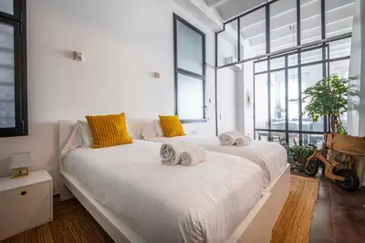 a bedroom with a large white bed with towels on it at Poble Nou I You Stylish Apartments in Barcelona