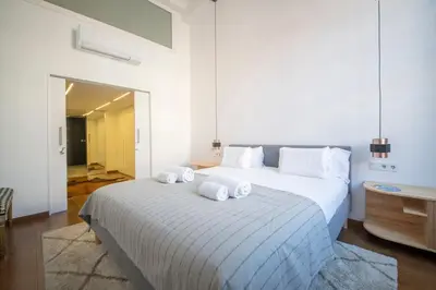 a bedroom with a large bed with towels on it at Poble Nou I You Stylish Apartments in Barcelona